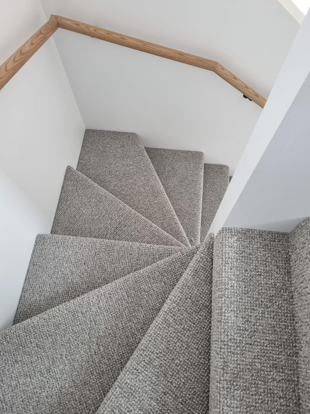 Neatly carpeted staircase with clean edges